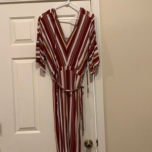 Deep V neck jumpsuit. Pants are crop comes right above ankle.